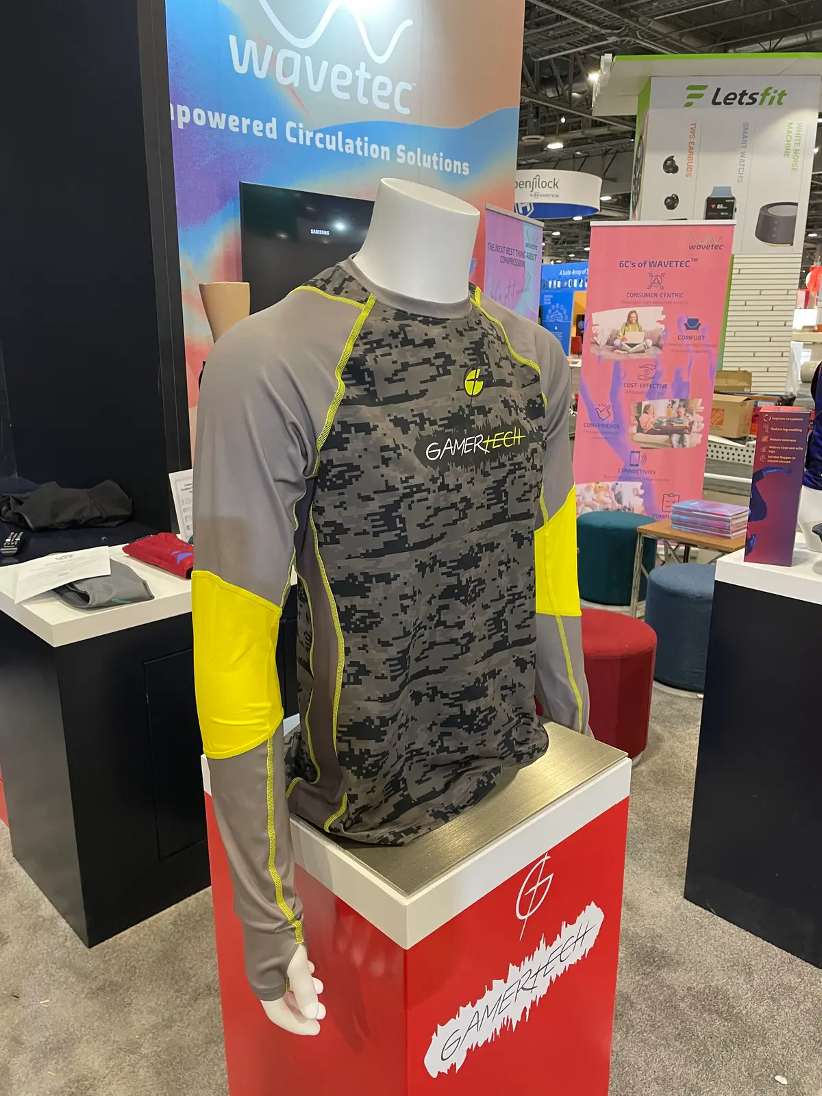 A GamerTech performance sleeve on a mannequin at a trade-show stand